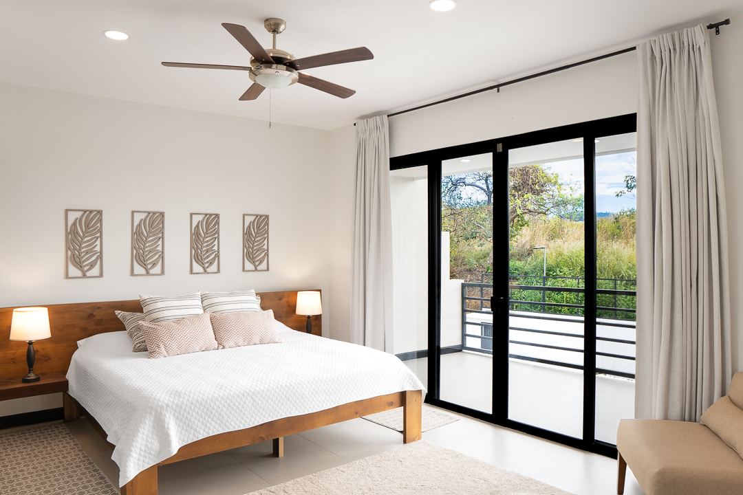 Bright ensuite bedroom with balcony doors at Cacique Retreat, Guanacaste