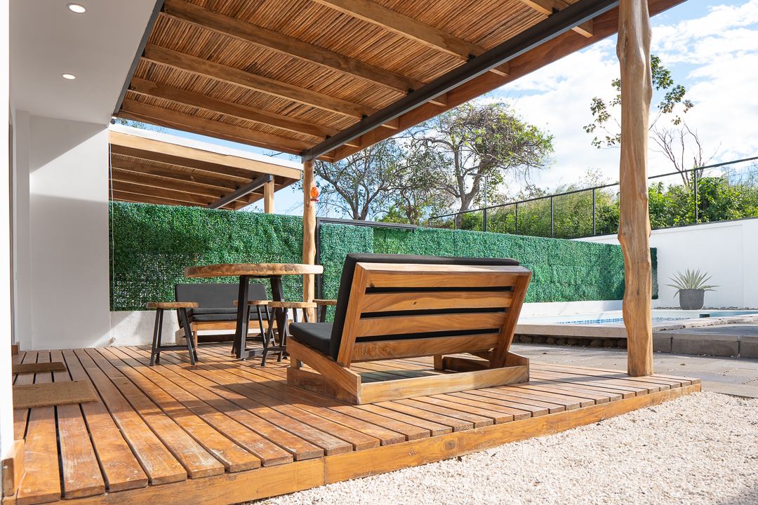 Covered wood deck with outdoor seating at Cacique Retreat, near Playa Hermosa