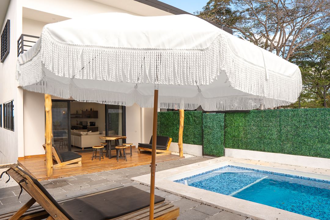 Sun loungers and umbrella beside the private pool at Cacique Retreat, Guanacaste